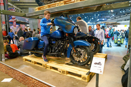 MILAN, ITALY - NOVEMBER 11, 2017: visitors try out a motorcycle at the EICMA 2017 - 75th...