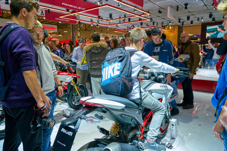 MILAN, ITALY - NOVEMBER 11, 2017: a visitor try out a motorcycle at the EICMA 2017 - 75th International Motorcycle Exhibition.のeditorial素材