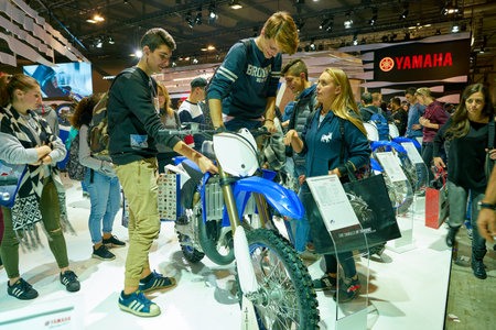 MILAN, ITALY - NOVEMBER 11, 2017: visitors try out a motorcycle at the EICMA 2017 - 75th...