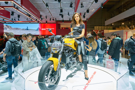 MILAN, ITALY - NOVEMBER 11, 2017: a model poses for the visitors during the EICMA 2017 - 75th International Motorcycle Exhibition.のeditorial素材