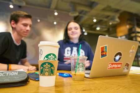 MOSCOW, RUSSIA - CIRCA OCTOBER, 2018: couple at Starbucks coffee shop in Moscow.のeditorial素材