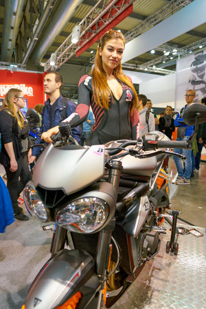MILAN, ITALY - NOVEMBER 11, 2017: a model poses for the visitors during the EICMA 2017 - 75th...