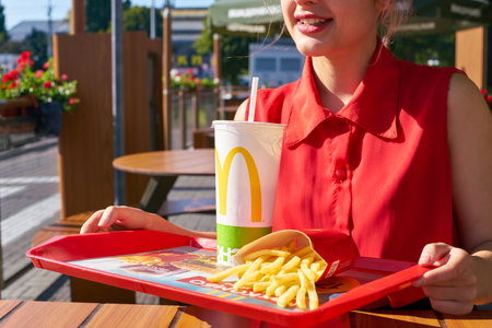 KALININGRAD, RUSSIA - CIRCA SEPTEMBER, 2018: young woman at McDonald's restaurant.