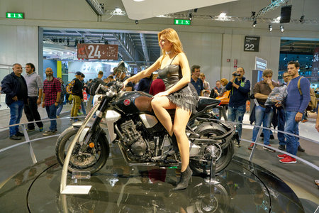 MILAN, ITALY - NOVEMBER 11, 2017: a model poses for the visitors during the EICMA 2017 - 75th...