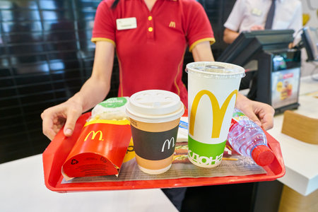 KALININGRAD, RUSSIA - CIRCA SEPTEMBER, 2018: worker with food served on a tray in McDonald's...
