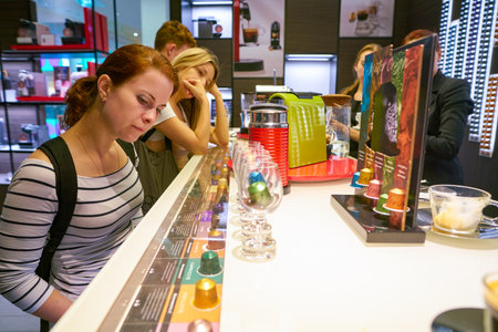 MOSCOW, RUSSIA - CIRCA SEPTEMBER, 2018: woman choose coffee at a Nespresso store in Moscow, Russia.