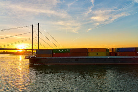 DUSSELDORF, GERMANY - CIRCA SEPTEMBER, 2018: ship sailing on the Rhine River at dusk in Dusseldorf.のeditorial素材
