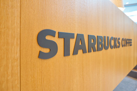 ZURICH, SWITZERLAND - CIRCA OCTOBER, 2018: close up shot of Starbucks sign in Zurich International Airport.のeditorial素材
