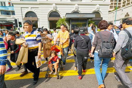 HONG KONG, CHINA - CIRCA FEBRUARY, 2019: diverse people crossing street in Hong Kong.のeditorial素材
