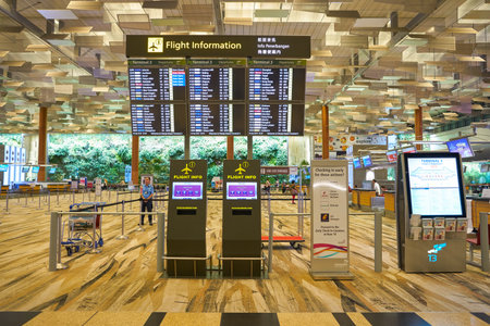 SINGAPORE - CIRCA APRIL, 2019: a flight schedule monitors at Singapore Changi International Airport.のeditorial素材