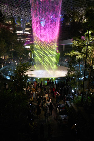 SINGAPORE - CIRCA APRIL, 2019: 40-meter HSBC Rain Vortex, the worldâs tallest indoor waterfall at the Jewel Changi Airport at night.のeditorial素材