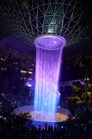 SINGAPORE - CIRCA APRIL, 2019: 40-meter HSBC Rain Vortex, the worldâs tallest indoor waterfall at the Jewel Changi Airport at night.のeditorial素材