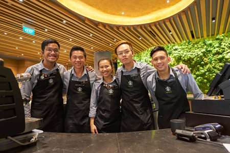 SINGAPORE - CIRCA APRIL, 2019: indoor group portrait of baristas in Starbucks flagship store at Jewel Changi airport.のeditorial素材