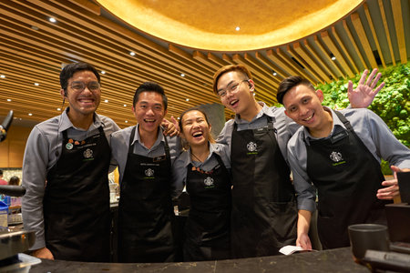 SINGAPORE - CIRCA APRIL, 2019: indoor group portrait of baristas in Starbucks flagship store at Jewel Changi airport.のeditorial素材