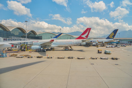 HONG KONG, CHINA - CIRCA APRIL, 2019: Cathay Dragon and Singapore Airlines aircrafts on tarmac in Hong Kong International Airport.のeditorial素材