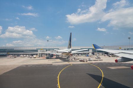 SINGAPORE - CIRCA APRIL, 2019: Changi International Airport seen from Singapore Airlines aircraft in...