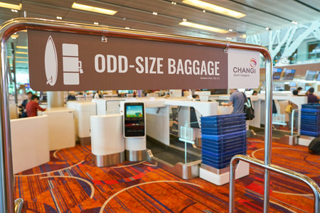 SINGAPORE - CIRCA APRIL, 2019: odd-size baggage sign seen at check-in area at Singapore Changi Airport.のeditorial素材