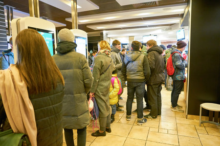 MOSCOW, RUSSIA - CIRCA OCTOBER, 2018: people use self-ordering kiosks at McDonald's restaurant.のeditorial素材