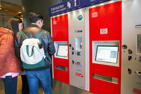 COLOGNE, GERMANY - CIRCA SEPTEMBER, 2018: a man use self-service ticketing kiosks at Cologne main...