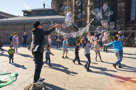 COLOGNE, GERMANY - CIRCA SEPTEMBER, 2019: street artist play with children in Cologne.のeditorial素材