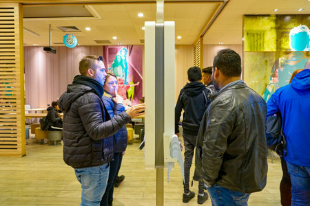 VENICE, ITALY - CIRCA MAY, 2019: people use self-service kiosk inside McDonald's restaurant in...