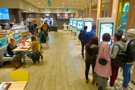 VENICE, ITALY - CIRCA MAY, 2019: people use self-service kiosk inside McDonald's restaurant in...