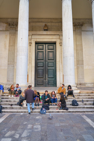 VENICE, ITALY - CIRCA MAY, 2019: people sit on the stairs in Venice.