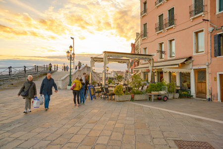 VENICE, ITALY - CIRCA MAY, 2019: a restaurant at a waterfront in Venice in the evening.のeditorial素材