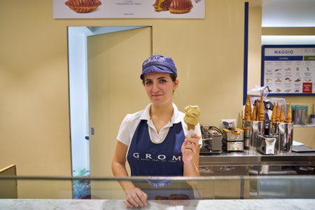 VERONA, ITALY - CIRCA MAY, 2019: indoor portrait of a worker at Grom gelateria in Veronaのeditorial素材