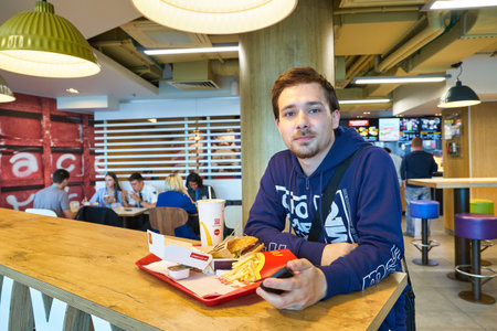 MOSCOW, RUSSIA - CIRCA MAY, 2019: indoor portrait of a man in McDonald's restaurantのeditorial素材