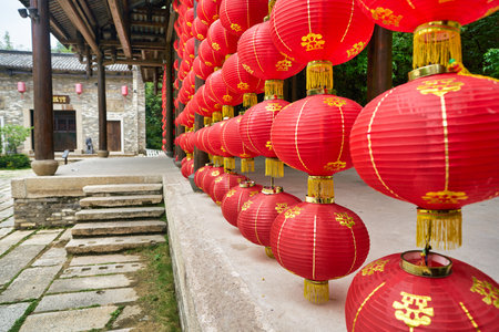 SHENZHEN, CHINA - CIRCA APRIL, 2019: Chinese lanterns decorate a building at Gankeng Hakka Town in Shenzhen. Gankeng Hakka Town is a tourist attraction by OCT Group.のeditorial素材