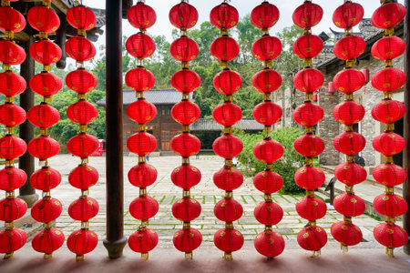 SHENZHEN, CHINA - CIRCA APRIL, 2019: Chinese lanterns decorate a building at Gankeng Hakka Town in Shenzhen. Gankeng Hakka Town is a tourist attraction by OCT Group.のeditorial素材