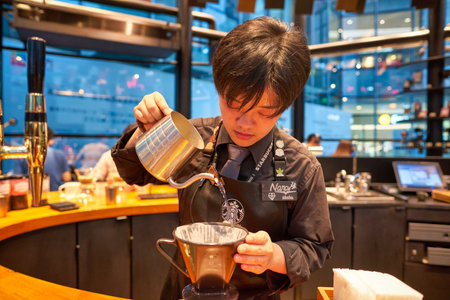 SHENZHEN, CHINA - CIRCA APRIL, 2019: barista prepare coffee at Starbucks Reserve Bar in Shenzhen. Starbucks Corporation is an American coffee company and coffeehouse chain.のeditorial素材