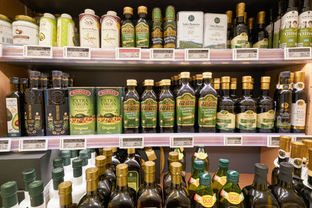 SHENZHEN, CHINA - CIRCA APRIL, 2019: bottles with oil on display at Ole' supermarket in MixC Shenzhen Bay.のeditorial素材