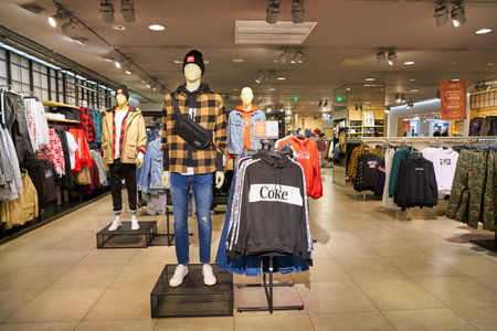 SHENZHEN, CHINA - CIRCA NOVEMBER, 2019: clothing on display in H&M store at Wongtee Plaza shopping mall. Hennes & Mauritz AB is a Swedish multinational clothing-retail company known for its fast-fashion clothing.のeditorial素材