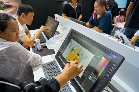 SHENZHEN, CHINA - CIRCA NOVEMBER, 2019: people try Huion device at China Hi-Tech Fair 2019 in...