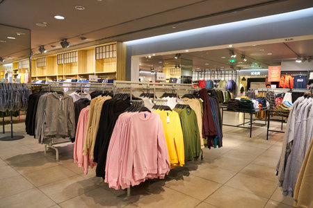 SHENZHEN, CHINA - CIRCA NOVEMBER, 2019: clothing on display in H&M store at Wongtee Plaza shopping mall. Hennes & Mauritz AB is a Swedish multinational clothing-retail company known for its fast-fashion clothing.のeditorial素材