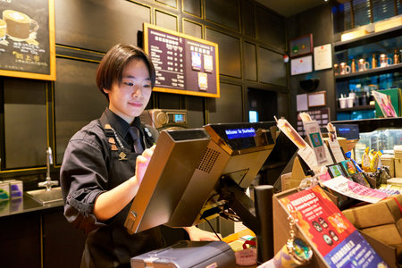 SHENZHEN, CHINA - CIRCA FEBRUARY,  2019: indoor portrait of a worker at Starbucks in Shenzhen.
