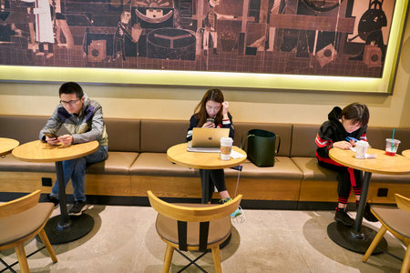 SHENZHEN, CHINA - CIRCA JANUARY  2019: people sit at Starbucks in Shenzhen.