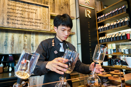 SHENZHEN, CHINA - CIRCA FEBRUARY,  2019: indoor portrait of handsome barista at Starbucks Reserve in Shenzhen.のeditorial素材