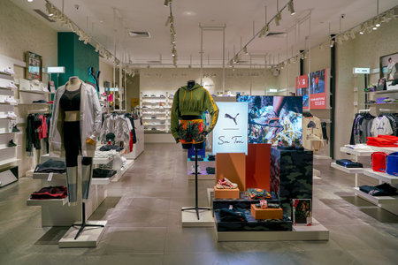 SINGAPORE - CIRCA APRIL, 2019: clothes and footwear on display at Puma Select store in the Shoppes...