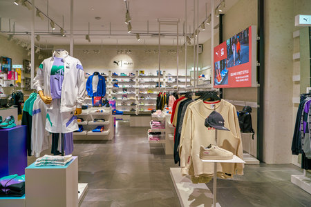 SINGAPORE - CIRCA APRIL, 2019: clothes and footwear on display at Puma Select store in the Shoppes...