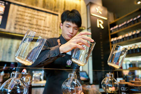 SHENZHEN, CHINA - CIRCA FEBRUARY,  2019: handsome barista working at Starbucks Reserve in Shenzhen.のeditorial素材