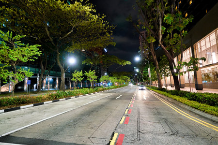 SINGAPORE - CIRCA APRIL, 2019: street level view of a road in Singapore at night.のeditorial素材
