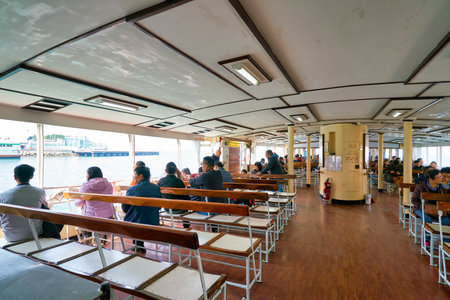 HONG KONG, CHINA - CIRCA JANUARY, 2019: people on a Star Ferry crossing Victoria Harbour. The Star Ferry is a passenger ferry service operator and tourist attraction in Hong Kong.のeditorial素材