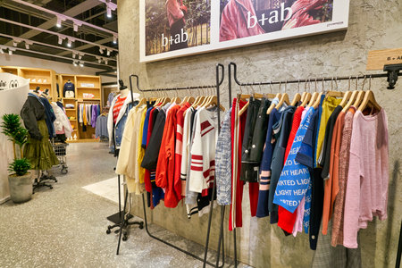 HONG KONG, CHINA - JANUARY 23, 2019: clothes on display at a store in New Town Plaza. New Town Plaza is a shopping mall in the town centre of Sha Tin, Hong Kong.のeditorial素材