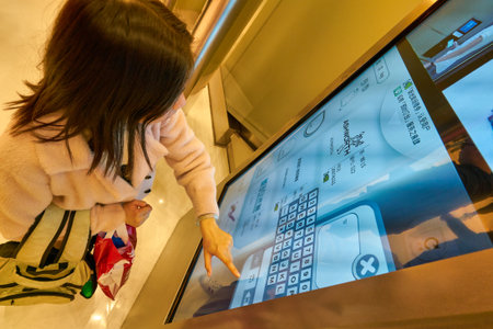 HONG KONG, CHINA - JANUARY 23, 2019: woman use interactive touchscreen at New Town Plaza shopping mall in Hong Kongのeditorial素材