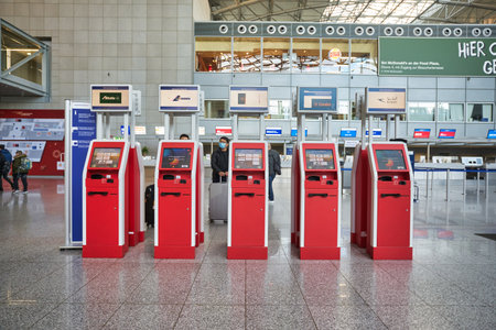 FRANKFURT AM MAIN, GERMANY - CIRCA JANUARY, 2020: red self check-in kiosks as seen at Frankfurt am...