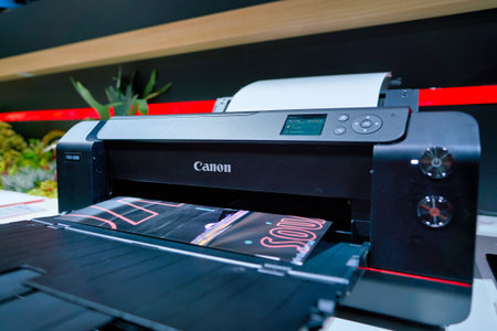 COLOGNE, GERMANY - CIRCA SEPTEMBER, 2018: close up shot of professional printer at Canon stand at the Photokina Exhibition.のeditorial素材