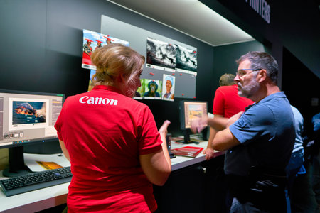 COLOGNE, GERMANY - CIRCA SEPTEMBER, 2018: Canon sign seen on red T-shirt of staff at the Photokina Exhibition. Photokina is a leading trade fair for the worldwide photo industry.のeditorial素材